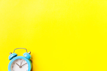 Ringing twin bell vintage classic alarm clock Isolated on yellow colourful trendy modern...