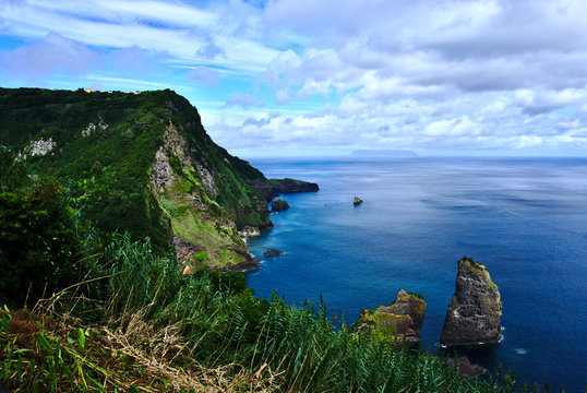 Coastline on Flores Island with Corvo Island in the background Azores Portugal