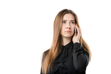 Portrait of a young caucasian woman in a black shirt and long flowing hair using hand-holding technology phone, taking a call against white isolate background