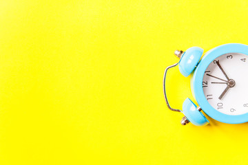 Ringing twin bell vintage classic alarm clock Isolated on yellow colourful trendy modern...