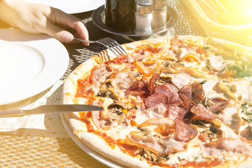 pizza with pepperoni, salami, pepper, cheese, close-up.
