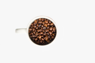 coffee beans brown closeup with blurred background in Cup on white isolated background