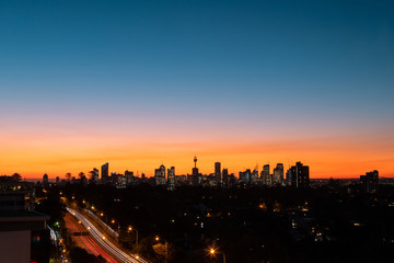 Sydney skyline with orange blue sky at dusk.