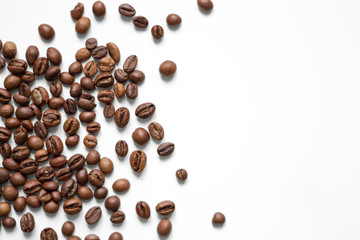 brown coffee grains on a white isolated background with space top view