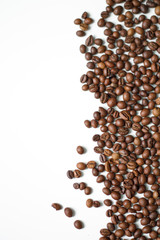 brown coffee grains on a white isolated background with space top view