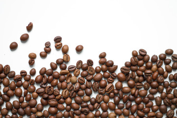 brown coffee grains on a white isolated background with space top view