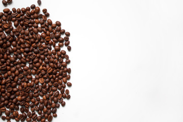 brown coffee grains on a white isolated background with space top view