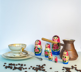 the cup of coffee and russian dolls on the white background