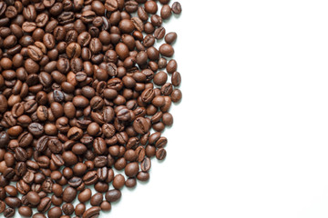 brown coffee grains on a white isolated background with space top view