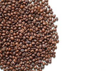 brown coffee grains on a white isolated background with space top view