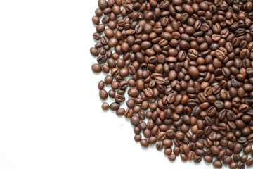 brown coffee grains on a white isolated background with space top view