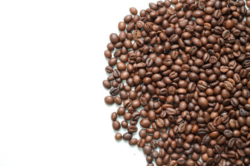 brown coffee grains on a white isolated background with space top view