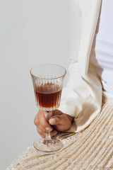 Woman helding a cup of vermouth, an italian aromatized and fortified white wine flavored with...