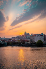 Obraz premium Scenic View of the Old Town Architecture with Vltava River, Charles Bridge and St.Vitus Cathedral in Prague, Czech Republic, Sunset Time