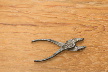 Old tools. Pliers  Wooden background