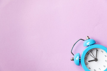 Ringing twin bell vintage classic alarm clock Isolated on purple violet pastel colourful...