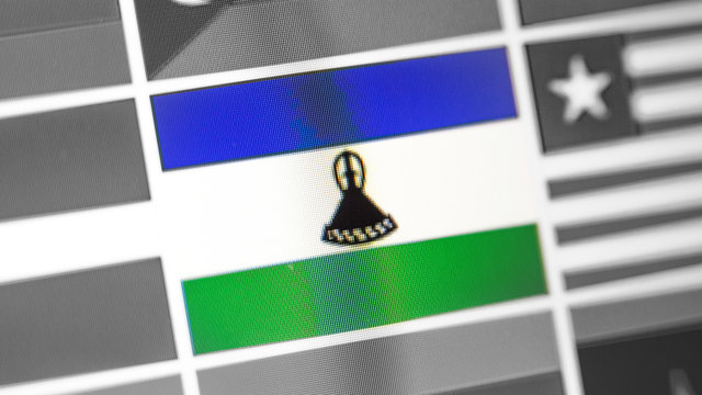 Lesotho national flag of country. Lesotho flag on the display, a digital moire effect. - Powered by Adobe