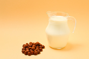 Hazelnut milk in a jar and nuts.