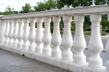 Fototapeta na wymiar white palace railings with blown props. Beautiful classical architecture. Luxury street railings.