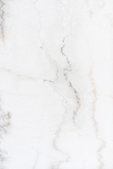 texture of white limestone with dark streaks. Very beautiful background. Abstract pattern for the screen.