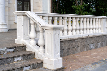 white palace railings with blown props. Beautiful classical architecture. Luxury street railings.