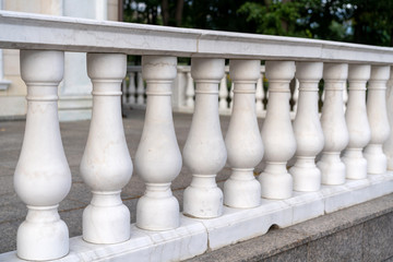 white palace railings with blown props. Beautiful classical architecture. Luxury street railings.