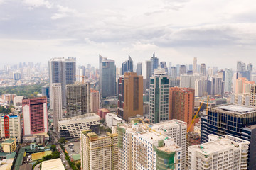 Fototapeta premium Modern city. The city of Manila, the capital of the Philippines. Modern metropolis in the morning, top view. Modern buildings in the city center.