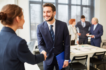 Business man shares handshake with partner
