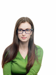 Obraz premium Young woman portrait. Long hired brunette female model in eyeglasses and green blouse looking aside of camera. Head shot. Vertical studio image isolated on white. 