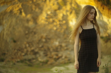 beautiful young blonde with long flowing hair on a blurry background