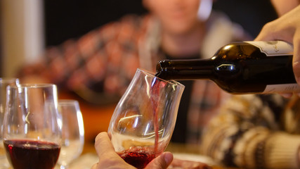A person pouring the wine in the glass
