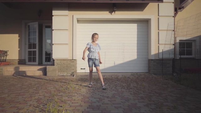 Adorable little girl playing with the small toy plane close-up. The girl launches the plane. The girl launches the toy plane and fearfully looks where it flies. Slow motion