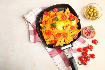 nachos with cherry and olives in cheese sauce