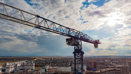 Fototapeta na wymiar the crane installation above the city, photographed by a drone from close range