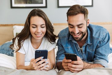 Beautiful young couple in love at home, laying in bed