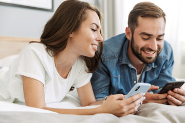 Beautiful young couple in love at home, laying in bed