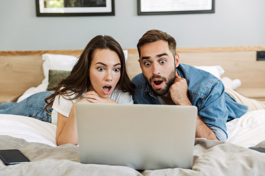 Beautiful Shocked Young Couple In Love At Home