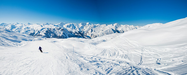 Skiers on a piste in alpine ski resort