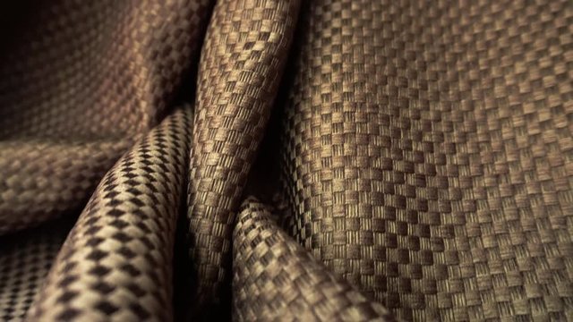 The texture of the fabric. Brown flowing fabric. Close-up. Can be used as a background.
