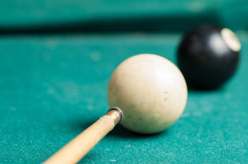 Old billiard ball 8 on a green table. billiard balls isolated on a green background