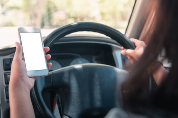 Woman in the car. Young business woman with phone in car. Woman holding smartphone with blank...
