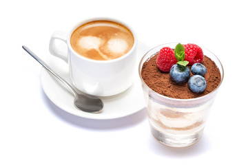 Cup of cofee and Classic tiramisu dessert with blueberries and raspberries in a glass isolated on a white background with clipping path