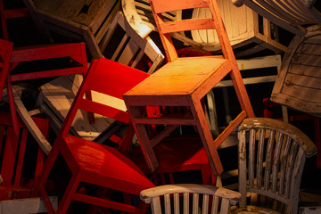 Stacked of colorful old chairs