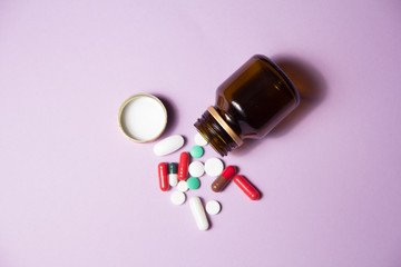 medicines for the patient. medicine and health. treatment of the disease. bright tablets. lilac background 