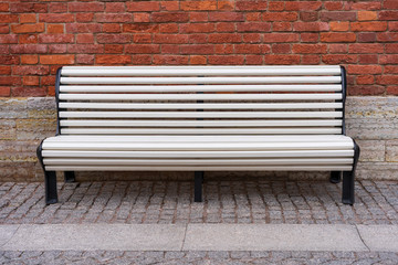 white bench on brick wall background