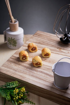 Pineapple tarts or nanas tart on wooden plate it is small bite size pastries filled with pineapple jam