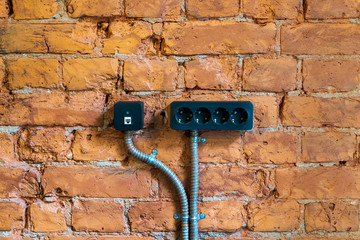 black socket on a red brick wall