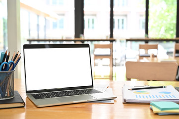 Mockup laptop computer on business office desk.