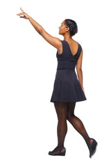 Back view of walking young black girl.