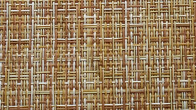 The texture of the fabric. Beige wicker fabric. Close-up. Can be used as a background.